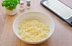 Grate the hard cheese on a fine grater. Transfer the cheese shavings to a bowl.