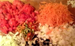 Chop the vegetables. Cut onions, eggplants, tomatoes and bell peppers partially into cubes, partly into half rings. You can simply grate ...