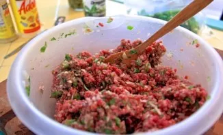 Stir thoroughly and pour in the oregano and chili sauce.