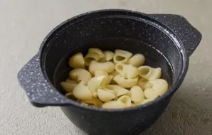 Boil the pasta in salted water until tender. Then rinse with cold water and dry.