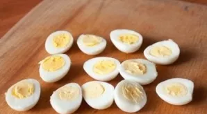 After boiling, let the eggs cool slightly, then cut them lengthwise into two equal parts.