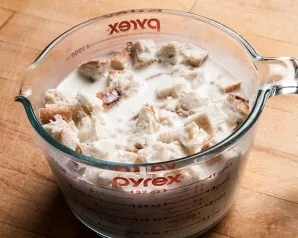 Cut the bread into cubes and soak in milk.