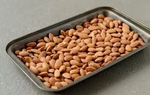 Preheat oven to 175 degrees. Put the almonds on a baking sheet and bake for 8-10 minutes.
