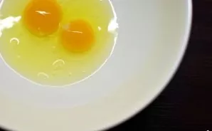 Break two eggs into a deep bowl, add a pinch of salt and pour water or milk. Stir well and gradually start adding flour and stir with a s...