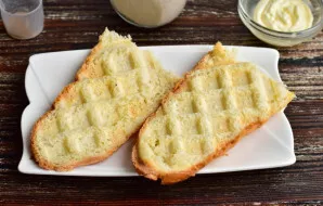 Cut the mini-baguette in half, and then in half lengthwise. Fry in a waffle or pan.