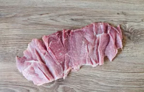 Wash and dry the piece of pork. Then make cuts all over the piece.