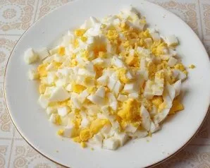 Boil the eggs hard and peel them. Cut the peeled eggs into small cubes.
