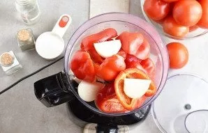 Place cleaned peppers and peeled onions in the bowl of a food processor.