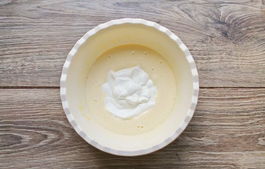 Pour sour cream into the egg mixture and beat again until smooth.