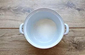 Pour sugar into the pot and add water. Put the pot on medium heat and bring to a boil.