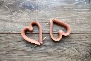 Peel the sausages if necessary, and cut lengthwise in the middle, but not completely, leave about 2 centimeters. Separate the ends in dif...