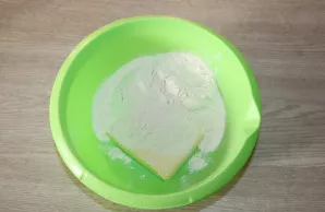 Add room temperature butter to a bowl, add flour.