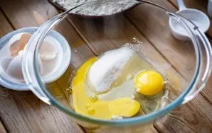 Break the eggs into a large bowl and add sugar.