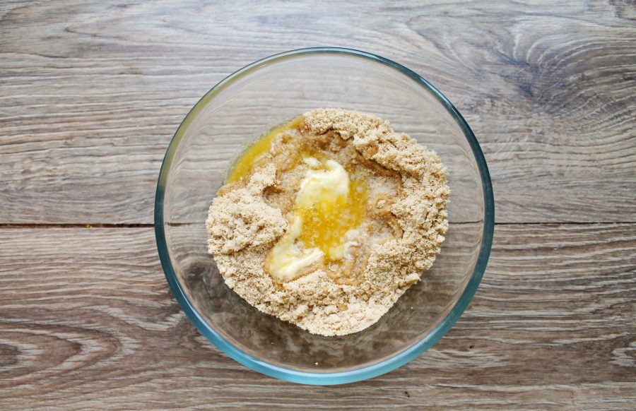 Grind the cookies with a blender and pour the melted butter. Mix everything until a wet mass that holds its shape when squeezed in your h...