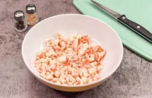 Cut the crab sticks into small cubes. Immediately transfer the slices to the bowl.