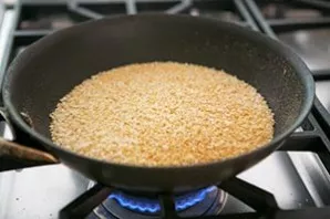 Add breadcrumbs to the pan and fry until golden brown. Add sesame seeds, stirring fry until brown.