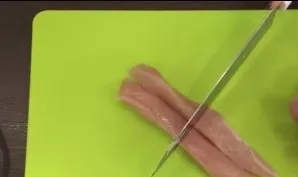 Cut the fillet into thin strips, and then cut it in half. You should get elongated pieces of meat.