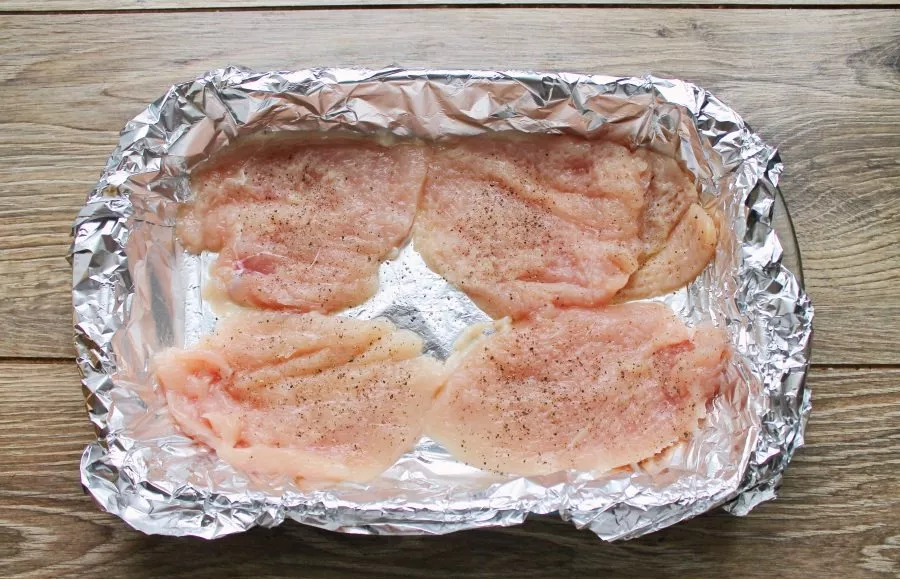 Line the baking form with foil and grease it with vegetable oil. Cut the breast lengthwise into 2 parts, beat it, rub it with salt and pe...