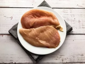 Cut the chicken breast into several parts and beat it a little.