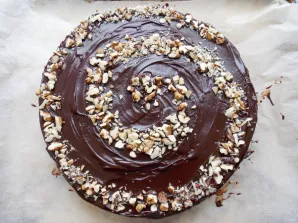 Decorate the cake as you wish, I sprinkled the nuts with a spiral. Put the dessert in the refrigerator for 2 hours. Our chocolate bird mi...