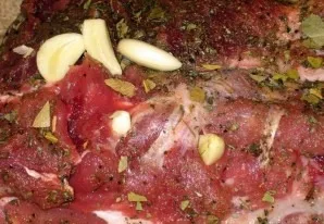 Peel the garlic and cut it into slices. In the meat with a thin knife we make recesses half the thickness and insert pieces of garlic int...