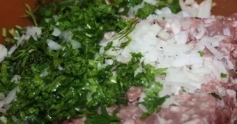 Now its time for the filling. Add finely chopped greens, finely chopped onion, two hard-boiled and finely chopped eggs to the minced meat...