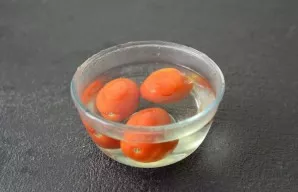 Make cross-cuts on tomatoes. Pour boiling water and leave for 10 minutes. Then peel the cuticle and cut into medium-sized slices.