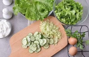 Finely chop the cucumbers and celery. Place in a bowl with the salad.