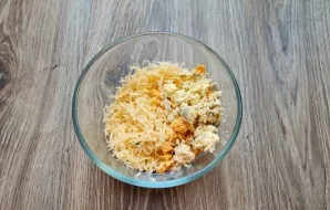 Grate the cheese on a fine grater and put it in a bowl. Cut the yolk and add it to the bowl with the cheese, mix.