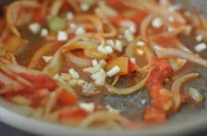 Cut the onion into half rings, cut the tomatoes into cubes, and the bell pepper into strips. Fry in a pan until tender. At the end, add f...
