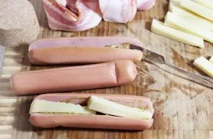Cut the cheese into small cubes, about the same length as sausages, or put a couple of pieces in it.