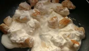 When the meat is fried until a beautiful golden color, reduce the fire and add sour cream to the meat. Cover the pan with a lid and simme...