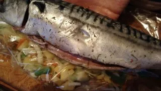 Season the fish with herbs (rub it well inside and out). Place the vegetables in the sleeve and place the fish on top.