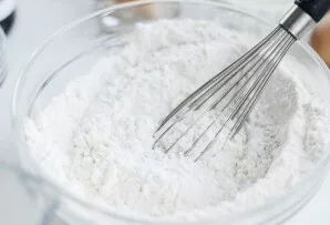 In a deep bowl, mix the flour with soda and baking powder.