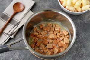 Cut the irises into small pieces with a knife, so it will be easier and faster to dissolve them. Put irises in butter.