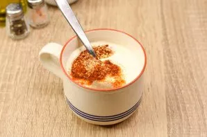 Add paprika, dried garlic, a little salt and ground pepper to greek yogurt. Stir.