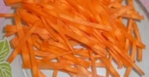 While the pork is cooking, cut the carrots into strips.