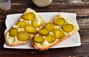 Grease with mayonnaise and put the pickled cucumber, which is cut into thin slices.