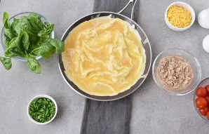 Heat the oil in a pan. Pour in half the egg mixture and toast the omelet, lifting the edges slightly, allowing the mixture to drain to th...