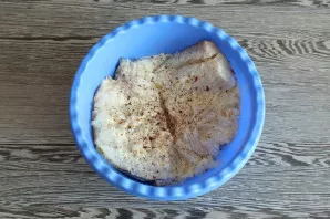 Cut the cod into large pieces, remove the bones. Transfer to a bowl, add salt, fish spices, 50 grams of sour cream. Stir and leave for at...