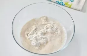 In a deep bowl, add flour and salt. Add the risen yeast.