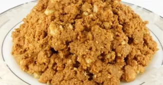 This is how the mixture will get. With slightly wet hands, form a pyramid. Add nuts.