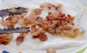 Place the bacon on a paper towel to absorb excess fat and let the bacon cool slightly.