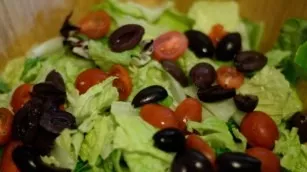 Cut the pitted olives in half.