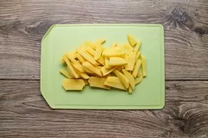 Peel the potatoes and cut into strips. Put the potatoes in the soup and cook for 15 minutes.