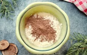Sift the flour with baking powder into the mixture and add cocoa powder. Mix everything thoroughly with a whisk until the dough becomes h...