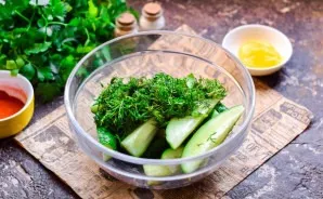 Wash and dry fresh fragrant dill, chop finely and add to cucumbers.