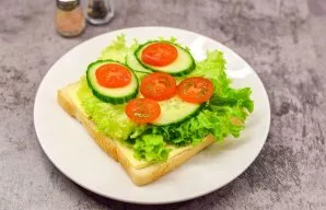 Put lettuce leaves on top. Chop tomatoes and cucumbers and put on lettuce leaves.