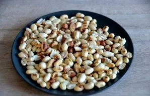 To get rid of the shells, transfer the fried peanuts to a towel and rub with your hands, the shells will easily separate.