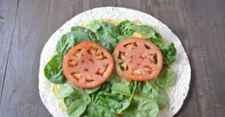 Lay out thin slices of tomatoes.